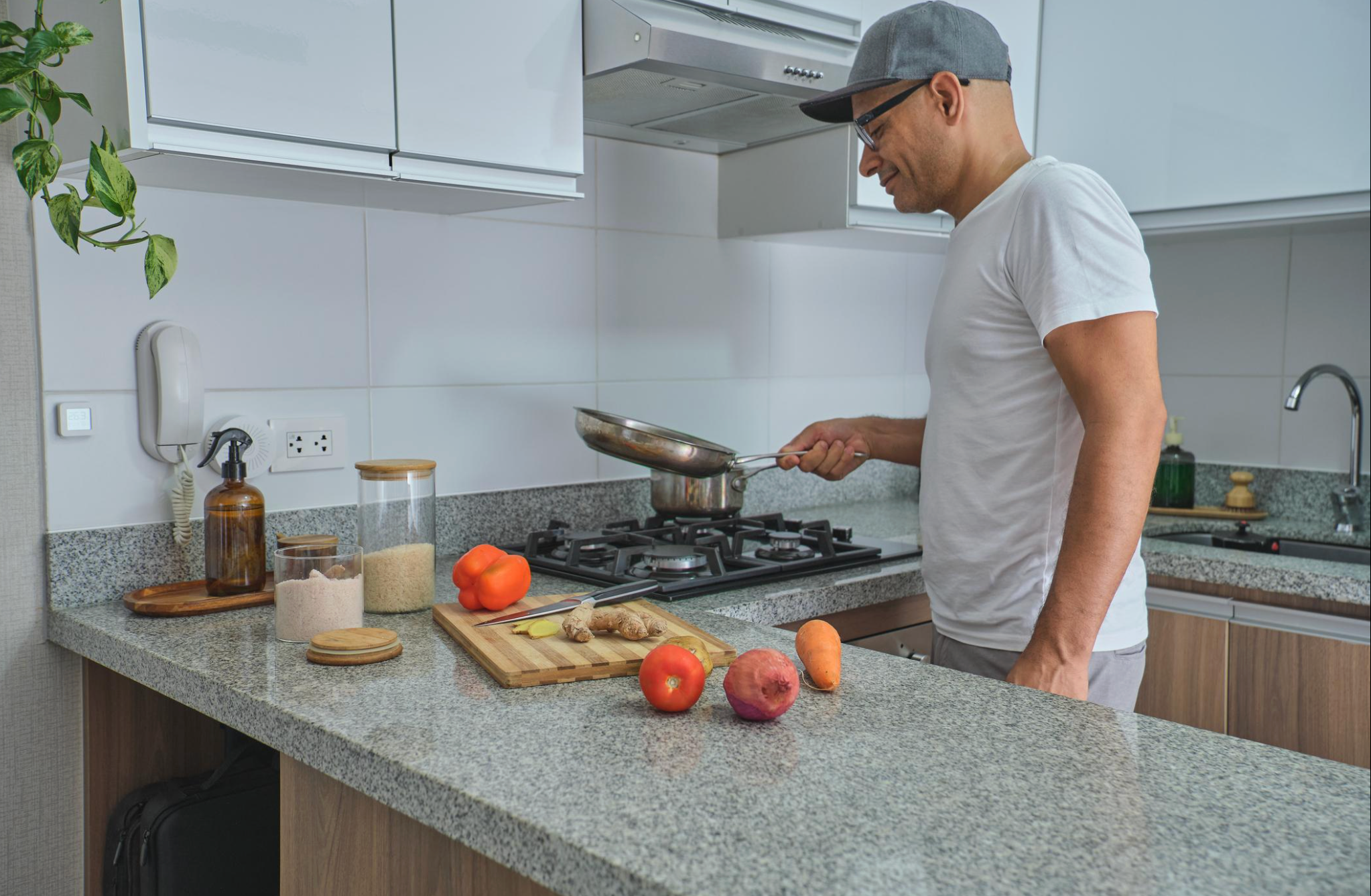 Man preparing healthy meal at home kitchen with fresh vegetables and whole foods for weight loss